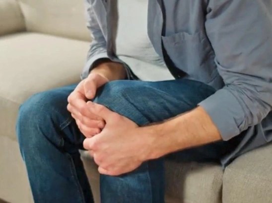 Holding a knee, seated